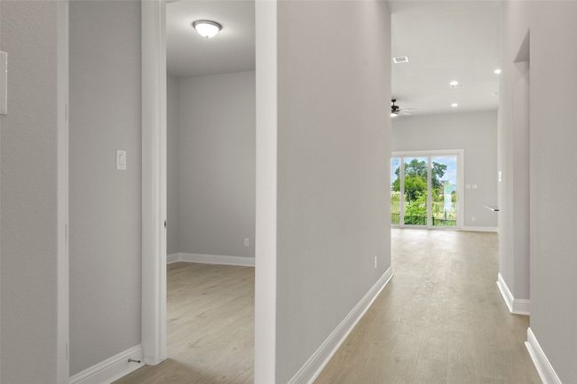 Hall featuring light wood-style floors and recessed lighting | Image 8