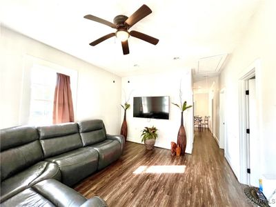 Living room featuring dark wood-type flooring and ceiling fan | Image 3