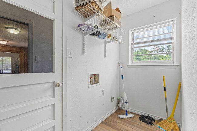 Washroom with wood finished floors, hookup for a washing machine, and plenty of natural light | Image 21