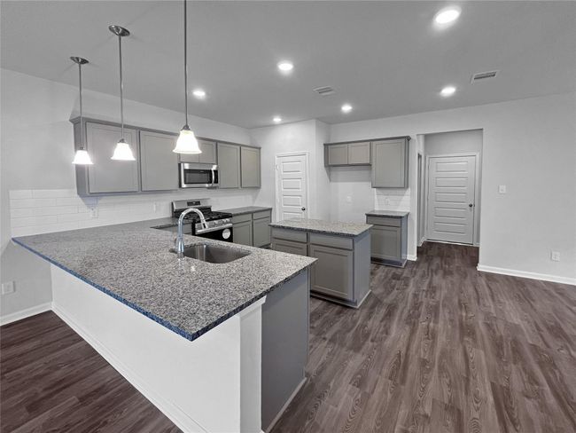 The Sparrow II- Kitchen Angled View. Home under construction. Sample floor plan photo used for illustrative purposes only. Upgrades, selections options, windows and colors may vary. | Image 6