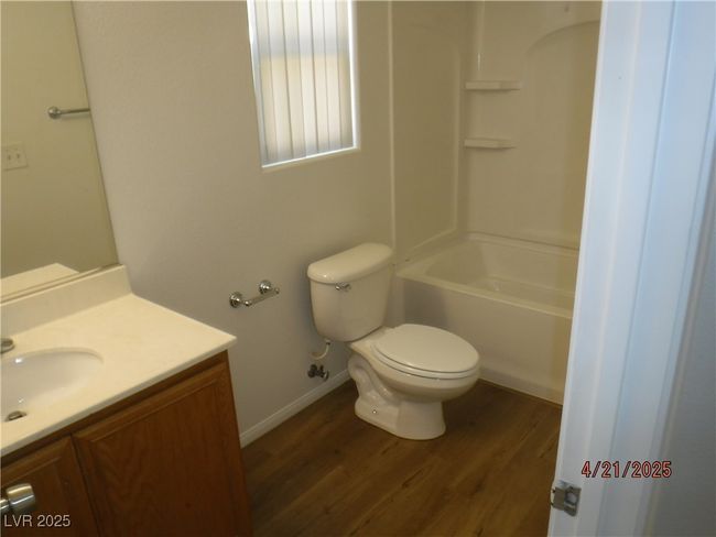 Full bathroom featuring toilet, vanity, wood finished floors, and baseboards | Image 10