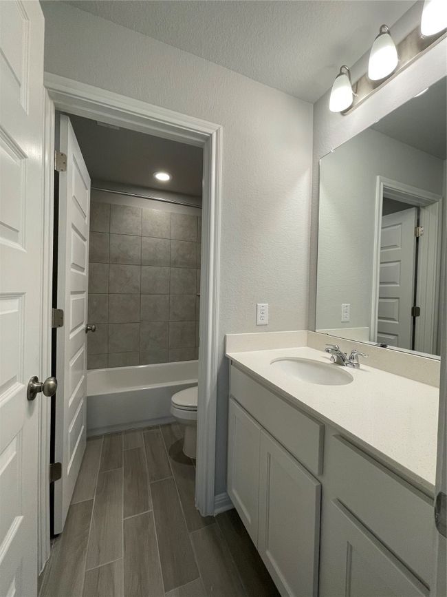 Bathroom with vanity, washtub / shower combination, and a textured ceiling | Image 19