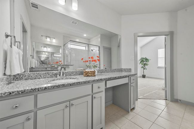 Bathroom featuring tile patterned flooring, vanity, and walk in shower | Image 25