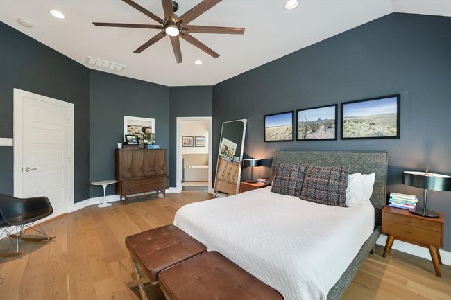 Bedroom featuring wood finished floors, recessed lighting, baseboards, connected bathroom, and ceiling fan | Image 16