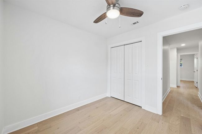 Unfurnished bedroom with light wood-style flooring, a closet, and ceiling fan | Image 32