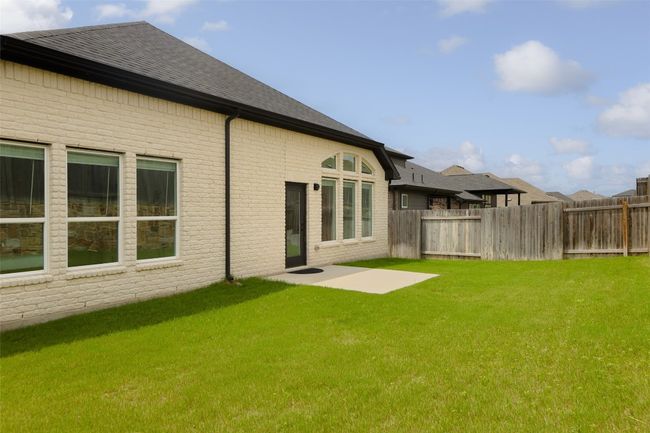 Relaxing rear patio with easy-care level yard. | Image 30