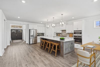 (Photo of decorated model, finishes will vary) The heart of this modern kitchen is the spacious center island | Image 3