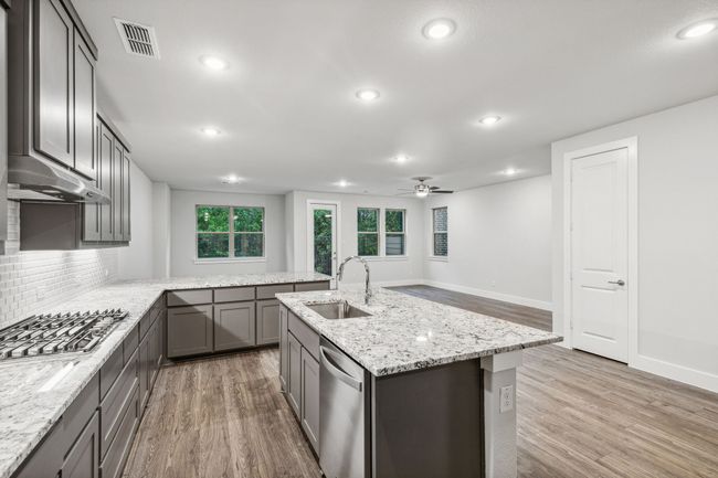 Kitchen with appliances with stainless steel finishes, light wood-type flooring, a ceiling fan, gray cabinetry, and recessed lighting | Image 10