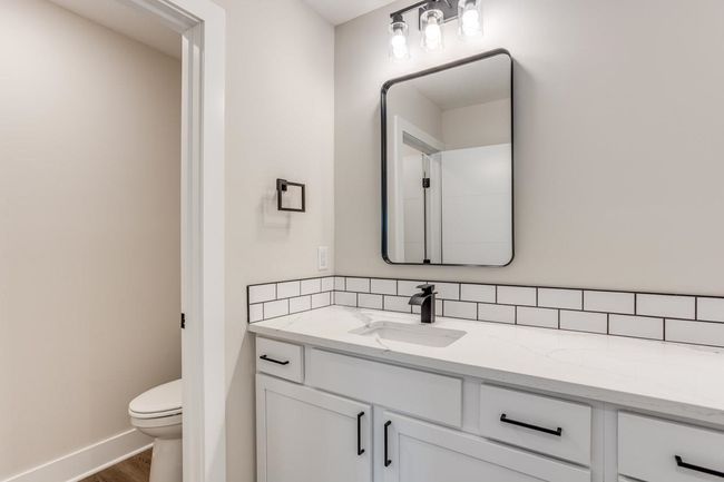 Bathroom featuring vanity, toilet, wood finished floors, and baseboards | Image 21