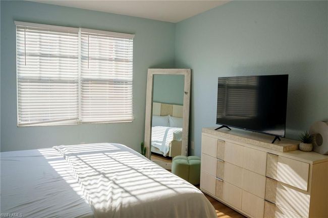 Bedroom featuring wood finished floors | Image 11