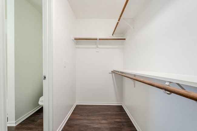 Spacious closet featuring dark wood-style floors | Image 20