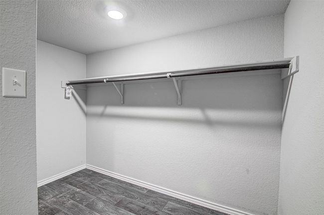 Spacious closet featuring dark wood-type flooring | Image 8