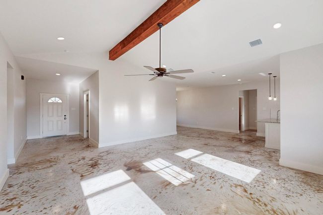 Unfurnished living room featuring recessed lighting, visible vents, a ceiling fan, and lofted ceiling with beams | Image 11