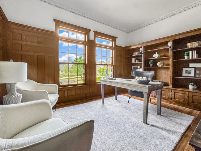 Rich wood paneling, built-in bookshelves, and tall | Image 25