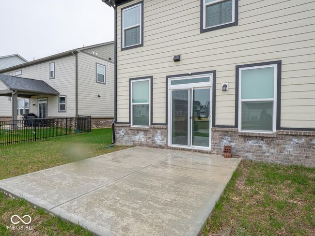 rear view of property featuring a patio area, brick siding, a yard, and fence | Image 56
