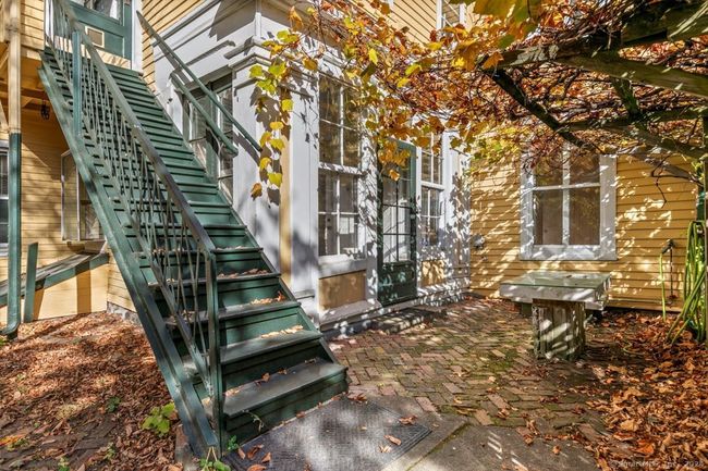 3 season porch and exterior stairs leading to 2nd floor rear apartment and main house laundry room. | Image 34