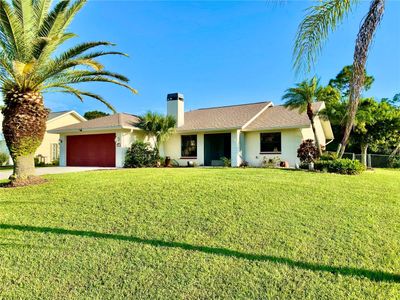 Tropical Landscape Frame this Unique Home....... Notice the Newer Roof..... Yes, That is a Real Chimney in FL ;)) | Image 1