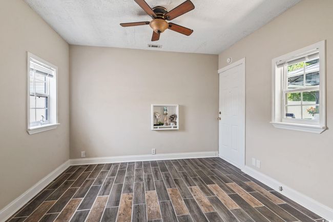 Spare room with dark wood-style flooring, a ceiling fan, and a textured ceiling | Image 10