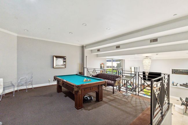 Private room equipped with a bar, ample seating and a pool table available to residents to enjoy. | Image 30