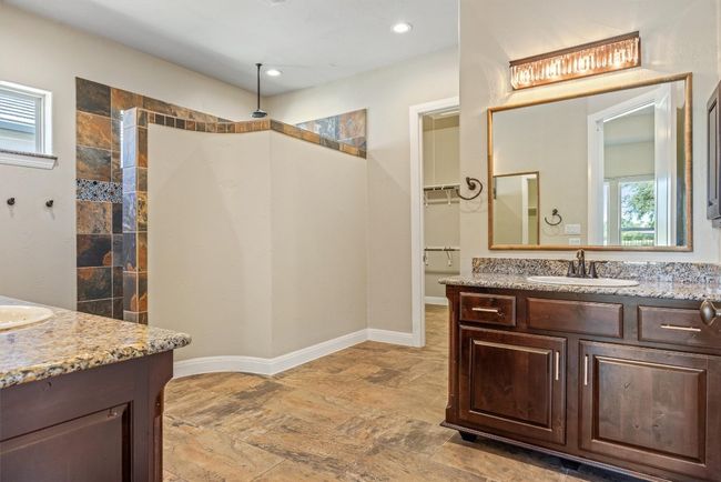 Full bathroom with vanity, a walk in shower, light stone finish flooring, recessed lighting, and a spacious closet | Image 29