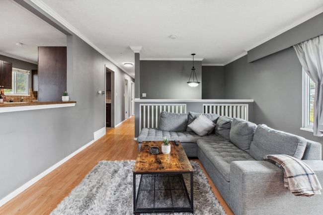 Living area featuring ornamental molding, baseboards, and light wood-type flooring | Image 7