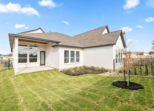 Rear view of house featuring a shingled roof, a patio area, a yard, stucco siding, and fence | Image 29