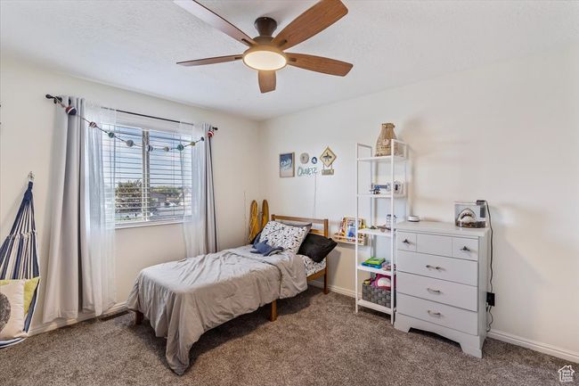 Bedroom with carpet floors, ceiling fan, and baseboards | Image 18