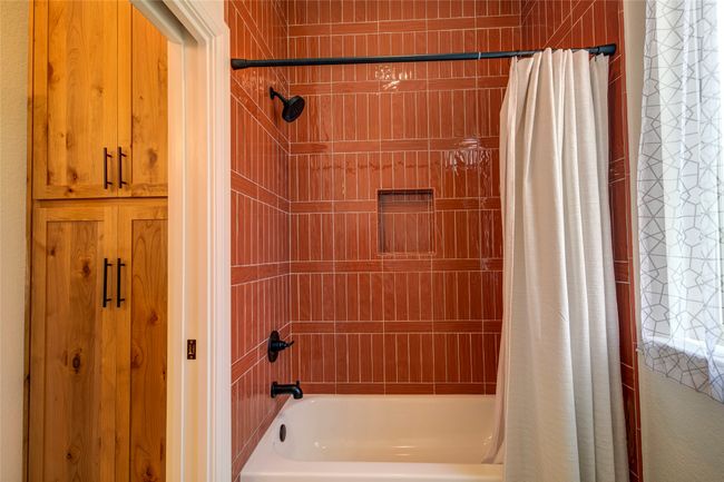 Bathroom featuring shower / bath combination with curtain | Image 27
