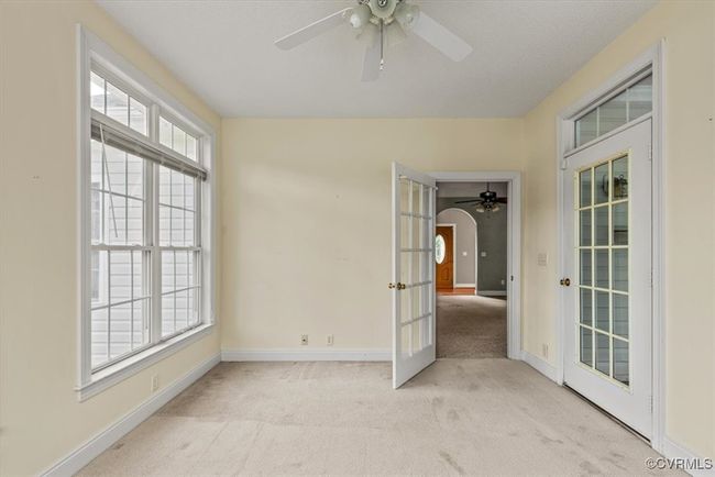 Unfurnished room featuring carpet flooring, ceiling fan, baseboards, and french doors | Image 24