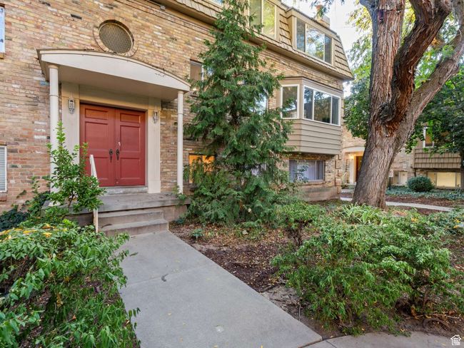 Entrance to property with brick siding and mansard roof | Image 18