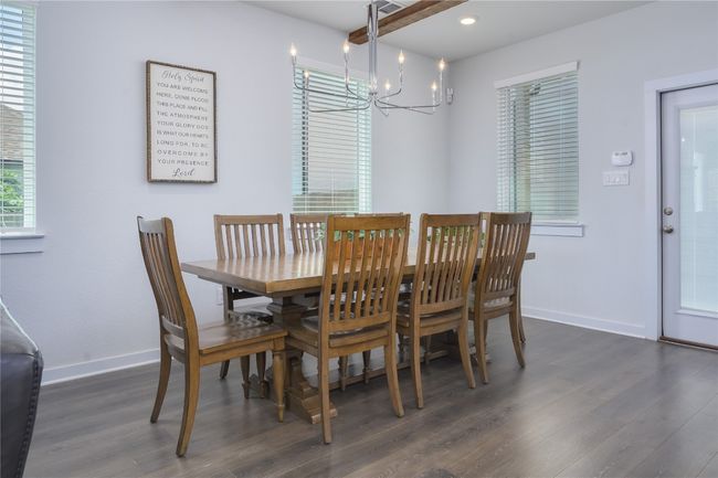 Dining room with a chandelier, dark wood-style flooring, and recessed lighting | Image 7