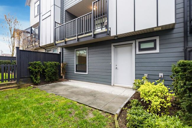 Back of house with a balcony, a patio, and fence | Image 13