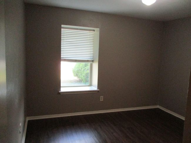 Bedroom 2 with dark wood look vinyl plank flooring | Image 10