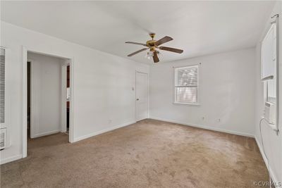 Unfurnished room with ceiling fan and carpet floors | Image 3