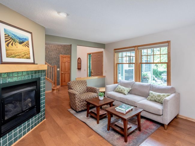 The living area features a cozy gas-burning fireplace, perfect for relaxing evenings. | Image 7