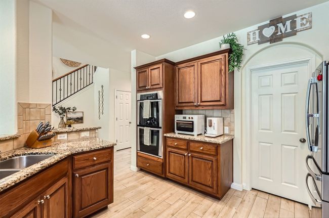 Convenient double ovens and oversized pantry located behind the door. | Image 11