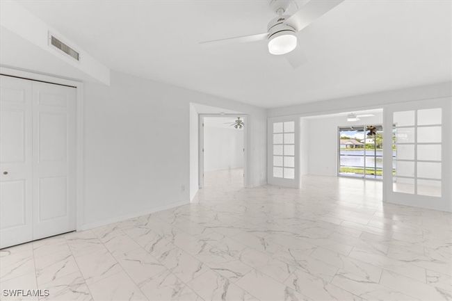 Tiled spare room featuring french doors and ceiling fan | Image 5