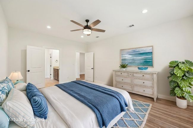 Virtually Staged Primary Bedroom with Vinyl Wood Plank floor, baseboards, visible vents, recessed lighting, and a ceiling fan | Image 20