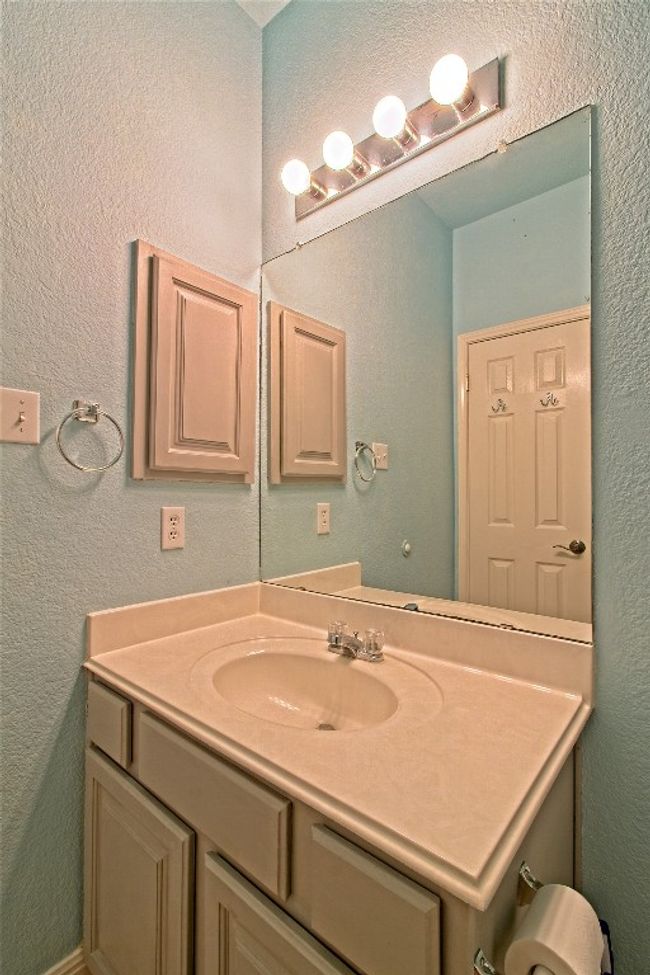Bathroom with vanity and a textured wall | Image 26