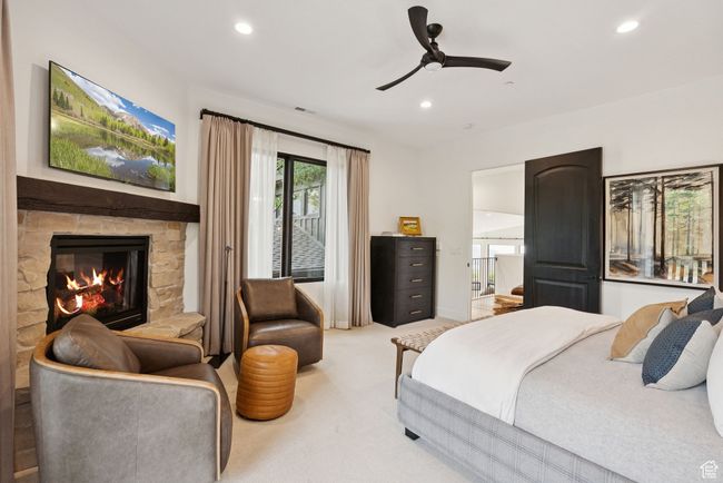 Carpeted bedroom featuring recessed lighting, a fireplace, and a ceiling fan | Image 67