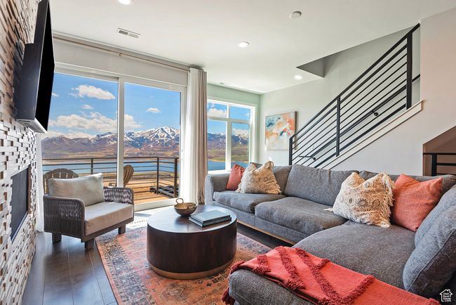 Living room with a mountain view, visible vents, recessed lighting, a large fireplace, and wood-type flooring | Image 6