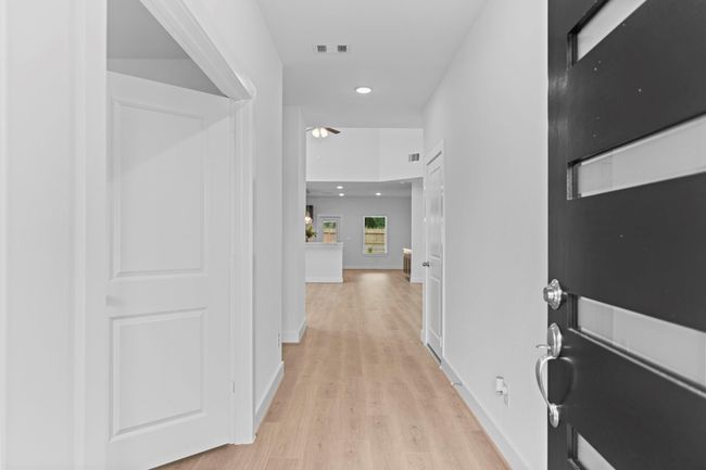 Step into the grand foyer with gorgeous woodlike vinyl plank flooring that flows throughout the main living areas, creating an immediate sense of space, light, and luxury. **Image Representative of Plan Only and May Vary as Built**. | Image 4