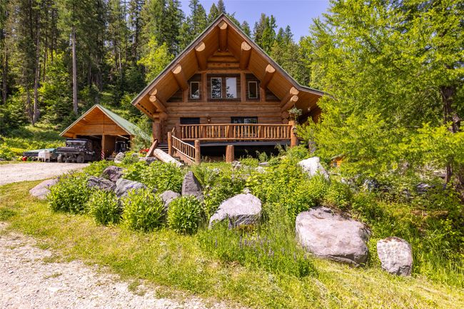 Log home with log siding and a carport | Image 97