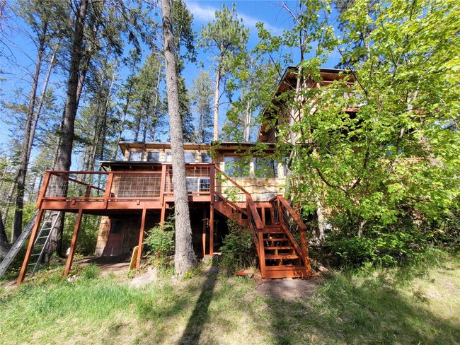 Rear view of property featuring stairs and a deck | Image 100