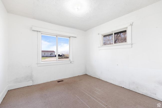 Carpeted spare room featuring visible vents and a textured ceiling | Image 11