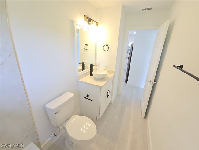 Bathroom with toilet, vanity, and wood finished floors | Image 33