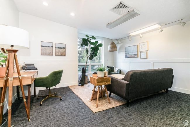 Carpeted office space featuring a decorative wall, a wainscoted wall, rail lighting, and recessed lighting | Image 14