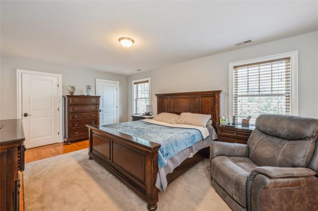 Primary Bedroom with light wood-style flooring | Image 13