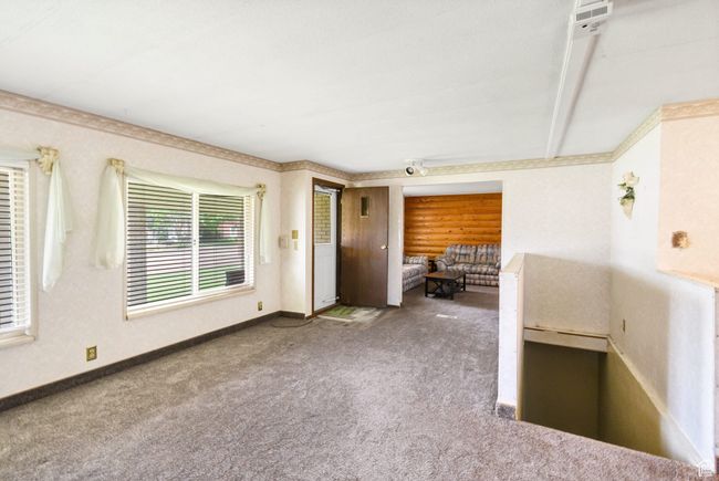 Carpeted spare room with baseboards | Image 7