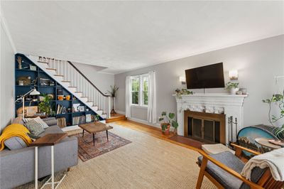 Living Room showing wood burning fireplace and built in bookcase. | Image 1